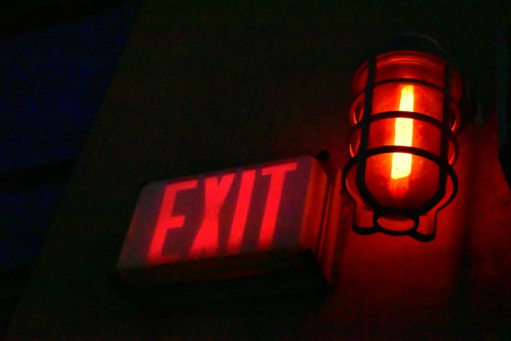 a red light that is on the side of a building